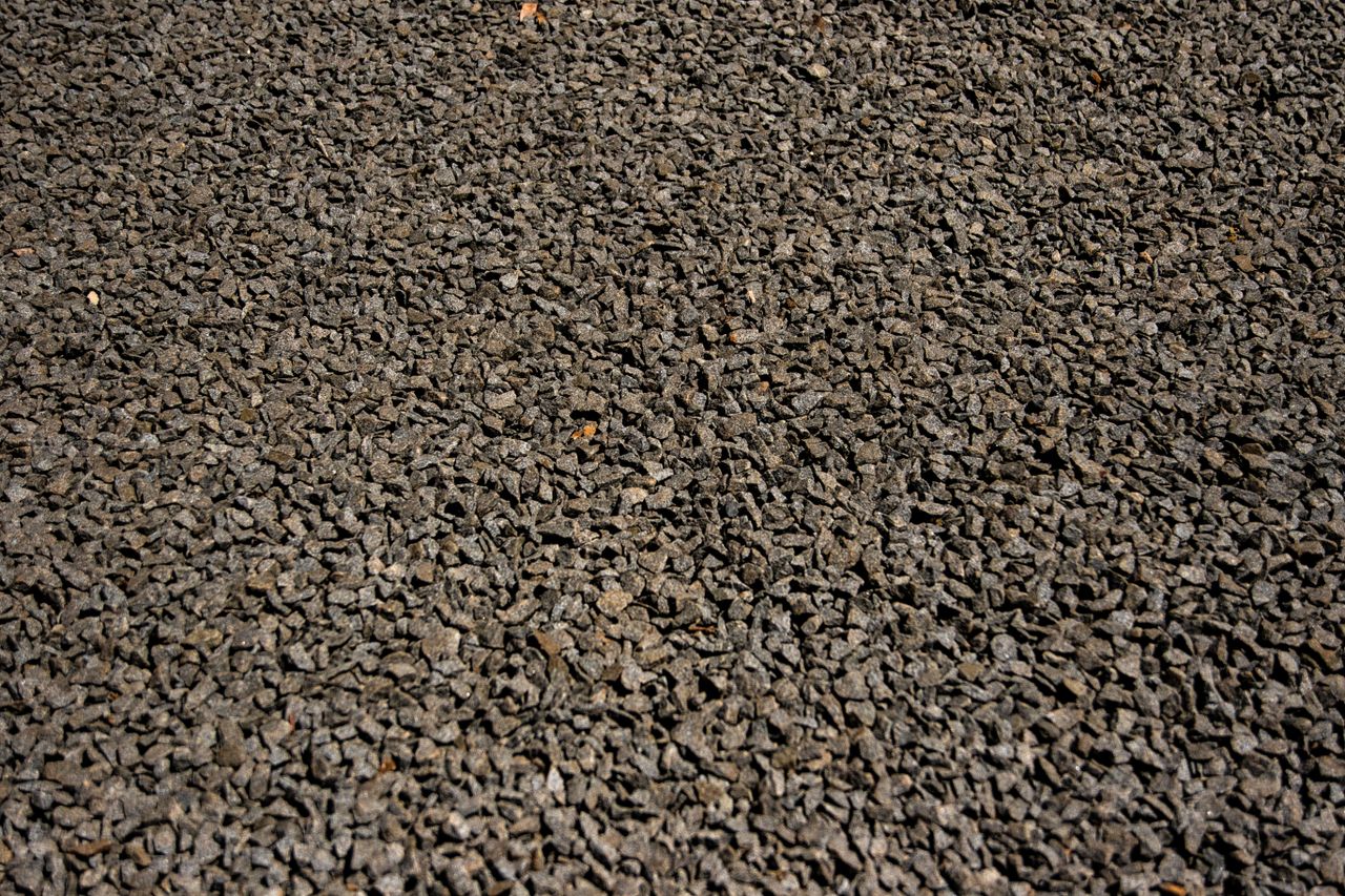 Detailed close-up shot of rough gravel texture for backgrounds or textures in design.